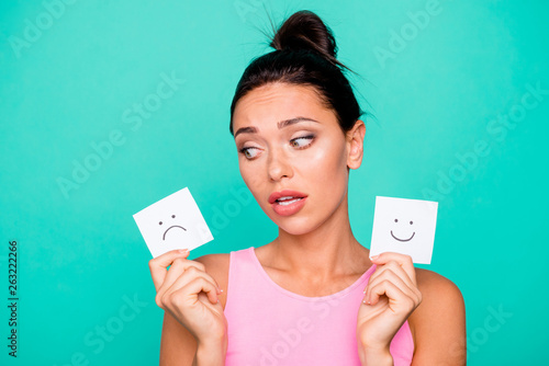 Close up photo beautiful amazing she her lady funny hairstyle hold hands arms paper mood drawings frightened pick select negative mask wear casual pink tank-top isolated teal turquoise background photo