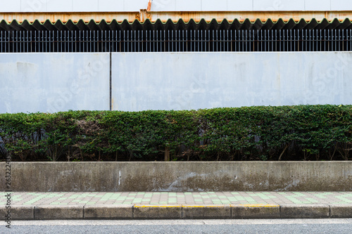 street wall background ,Industrial background, empty grunge urban street with warehouse brick wall © RobbinLee