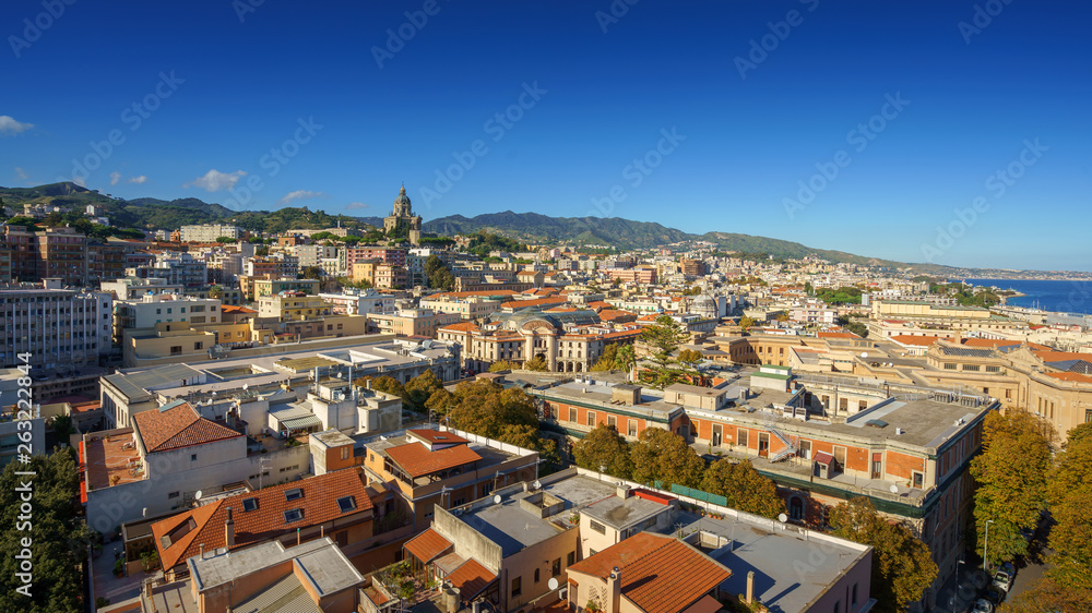 Panoramic top view of the local buildings with the trees, mountains and the sky in the beautiful city of Messina, Sicily, Italy