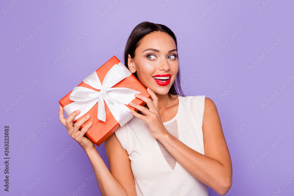 Close up photo beautiful amazing she her lady hold giftbox hands arms wondered look side empty space allure tempting lips pomade wear white formal-wear dress isolated violet purple background Close up photo beautiful amazing she her lady hold giftbox hands arms wondered look side empty space allure tempting lips pomade wear white formal-wear dress isolated violet purple background