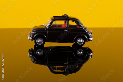 giocattolo di una  vecchia auto vintage con riflessi di luce colorata photo