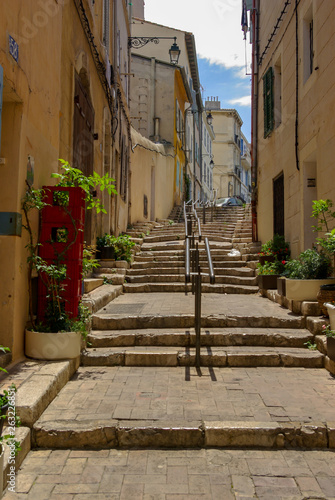 Fototapeta Naklejka Na Ścianę i Meble -  Stairs and railing in a lonely alley in Marseille, France