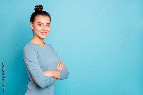 Close up side profile photo beautiful amazing she her lady arms crossed stylish hairstyle look wondered toothy cute self-confident wear casual sweater pullover isolated blue bright background photo