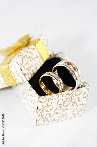 gold silver wedding rings in a gift box on a black background