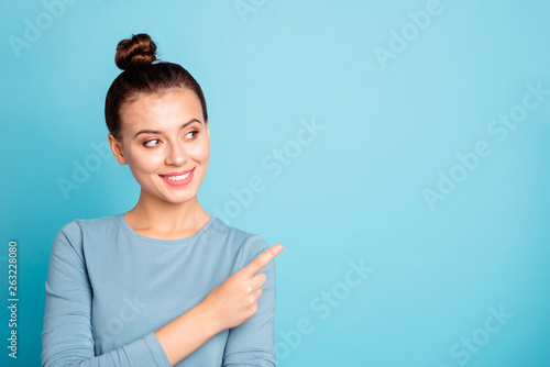 Close up photo beautiful amazing cute she her lady arm hand finger indicate empty space toothy advising buy buyer best low little price wear casual sweater pullover isolated blue bright background photo