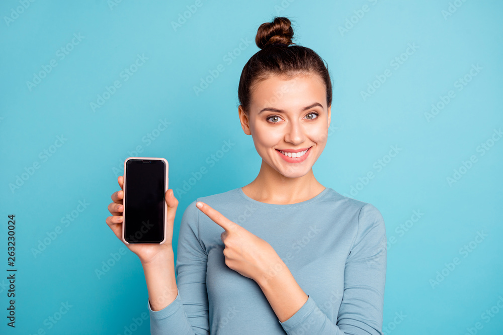Close-up portrait of her she nice-looking attractive sweet lovely cheerful teenage girl holding in hand new cool buying purchase ad advert isolated over bright vivid shine turquoise background - obrazy, fototapety, plakaty 
