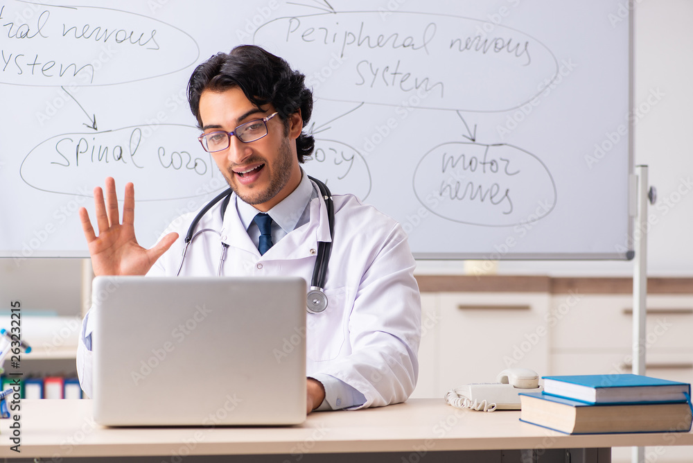 Young male doctor neurologist in front of whiteboard Young male doctor neurologist in front of whiteboard