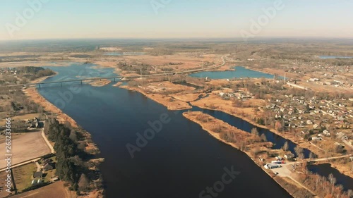 Aerial view of a city next to a river with a  bridge  photo