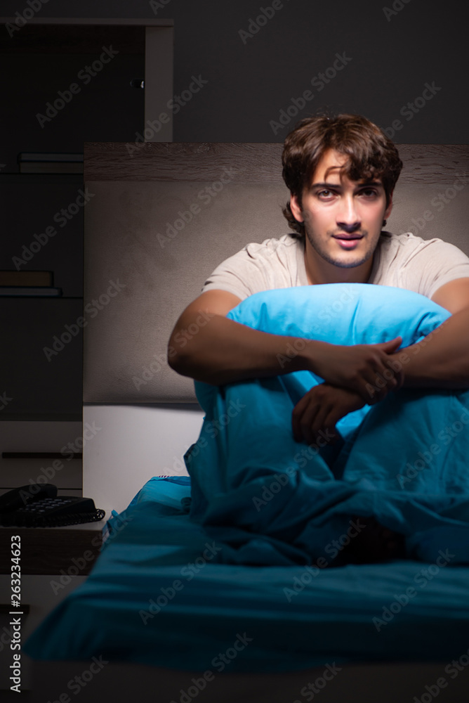 Young handsome man suffering from insomnia in bed Young handsome man suffering from insomnia in bed