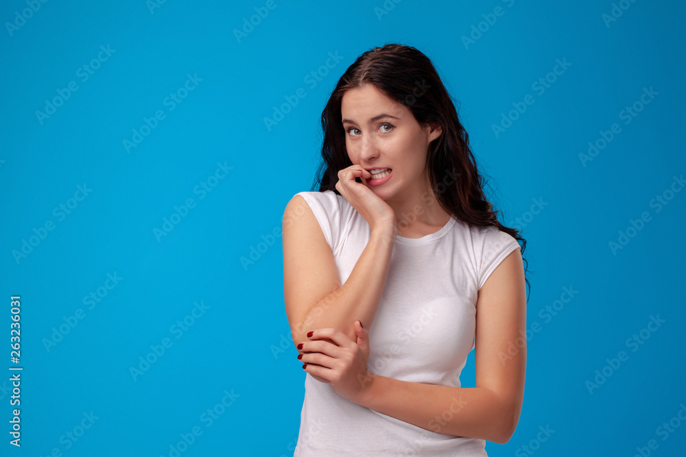 Thoughtful attractive young woman thinking on blue background Thoughtful attractive young woman thinking on blue background