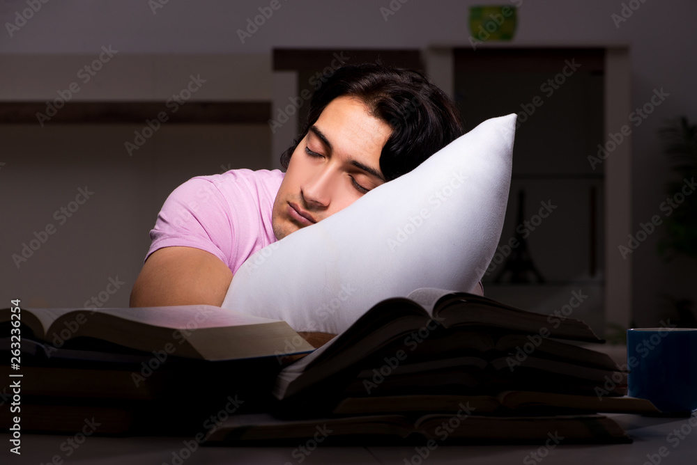 Male handsome student preparing for exams late at home Male handsome student preparing for exams late at home