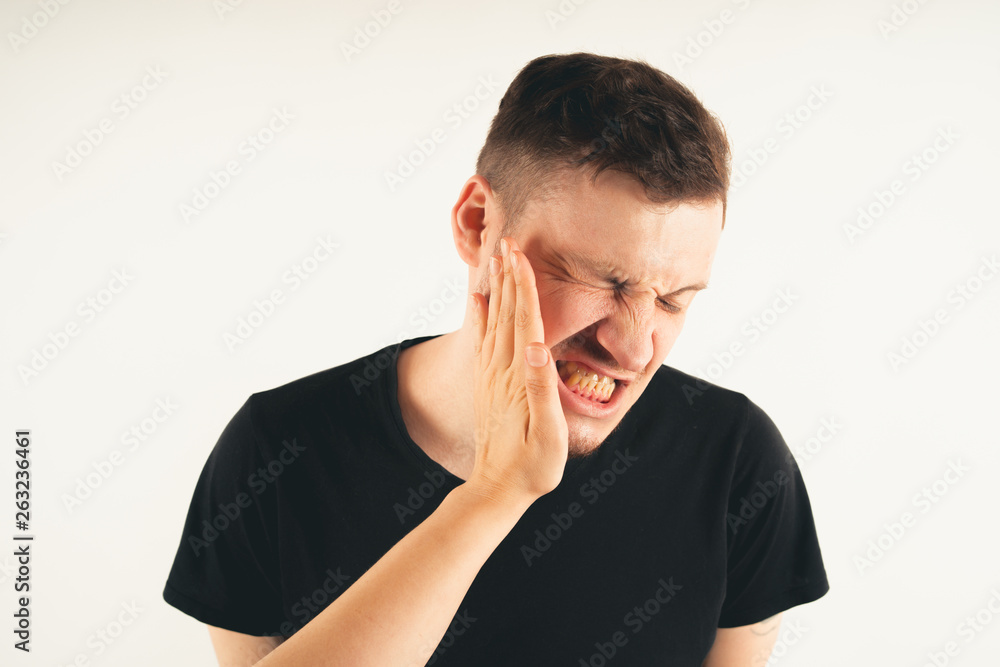 Emotional male getting slapped in face while shouting with closed eyes in fear on white background Emotional male getting slapped in face while shouting with closed eyes in fear on white background