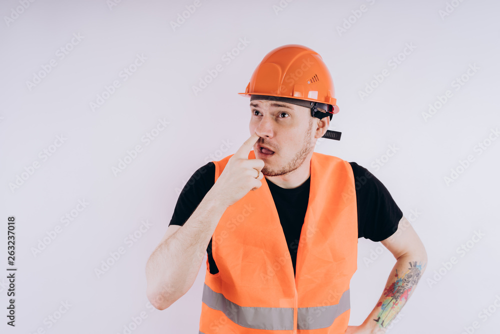 Man in working uniform on white background Portrait of young male in bright orange protective hardhat and vest looking at camera on white background Man in working uniform on white background Portrait of young male in bright orange protective hardhat and vest looking at camera on white background