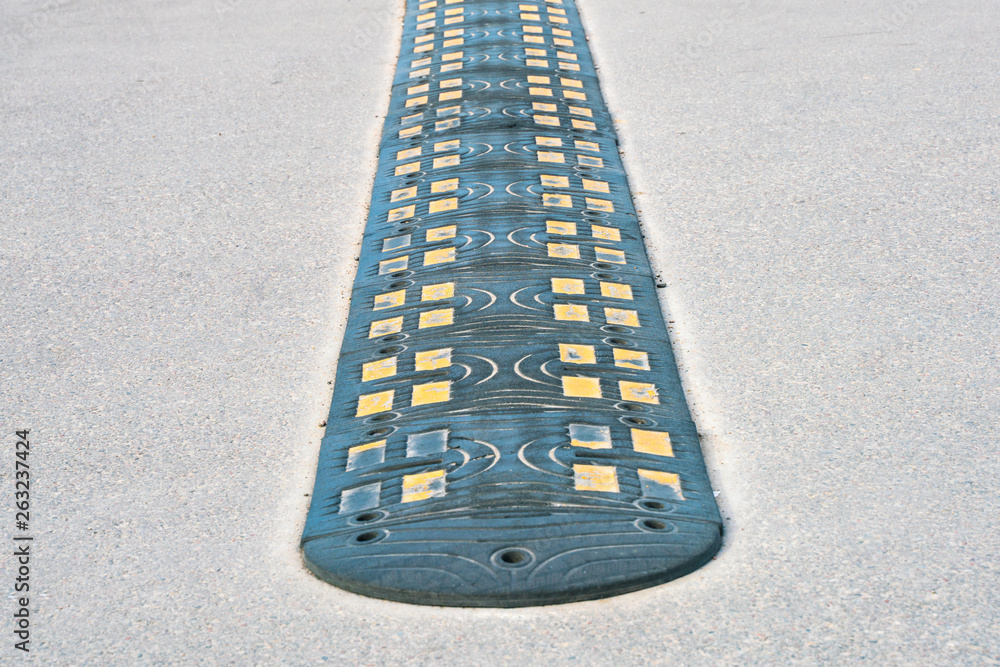 Fototapeta premium Obstacle on the road to reduce vehicle speed. Lying police officer.