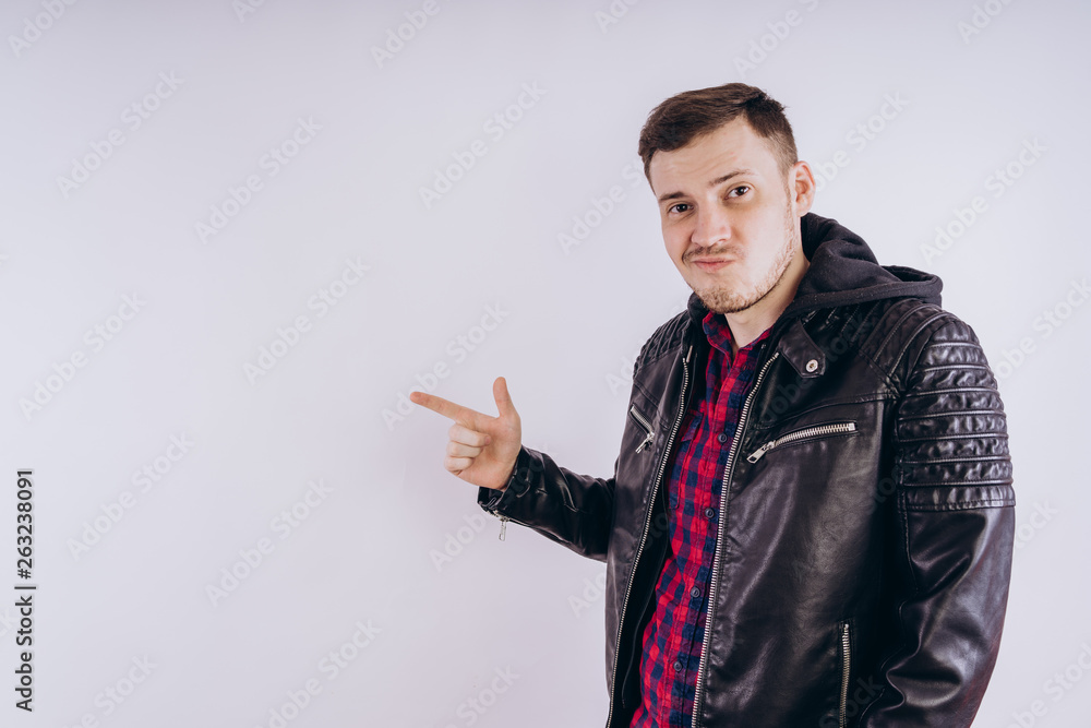 Man in trendy jacket on white background. Portrait of young male in leather jacket zipping up and smiling at camera on white background Man in trendy jacket on white background. Portrait of young male in leather jacket zipping up and smiling at camera on white background