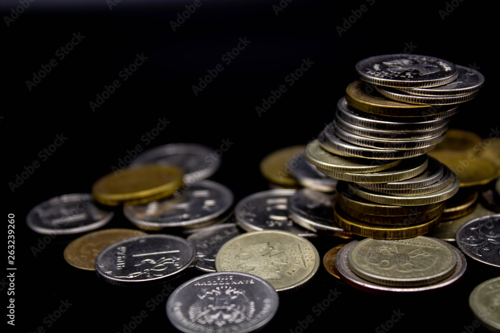 Coins stack on black background in concept wall and strong money. Coins stack on black background in concept wall and strong money.