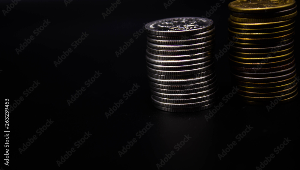 Coins stack on black background in concept wall and strong money. Coins stack on black background in concept wall and strong money.