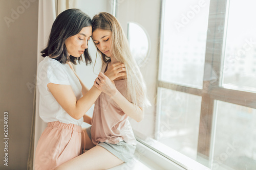 two lesbians making love indoors. close up photo. copy space. sexual  behavior concept. females going to have sex. woman holding a shoulder of  other one Stock Photo | Adobe Stock