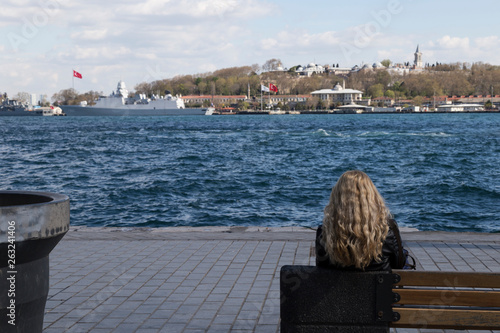 Canvas Print A lonely woman is sitting the seat and looking the sea in Istanbul