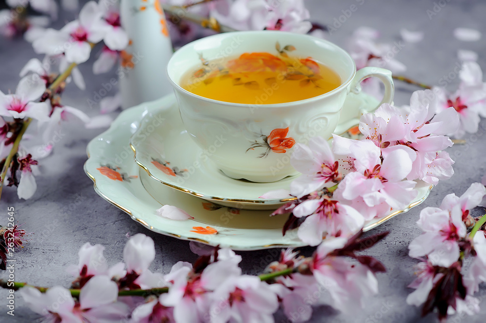 Cherry blossom(sakura) japanese Herb tea.The magic of tea, decorated with sakura flowers and sweets, spring mood, summer Cherry blossom(sakura) japanese Herb tea.The magic of tea, decorated with sakura flowers and sweets, spring mood, summer