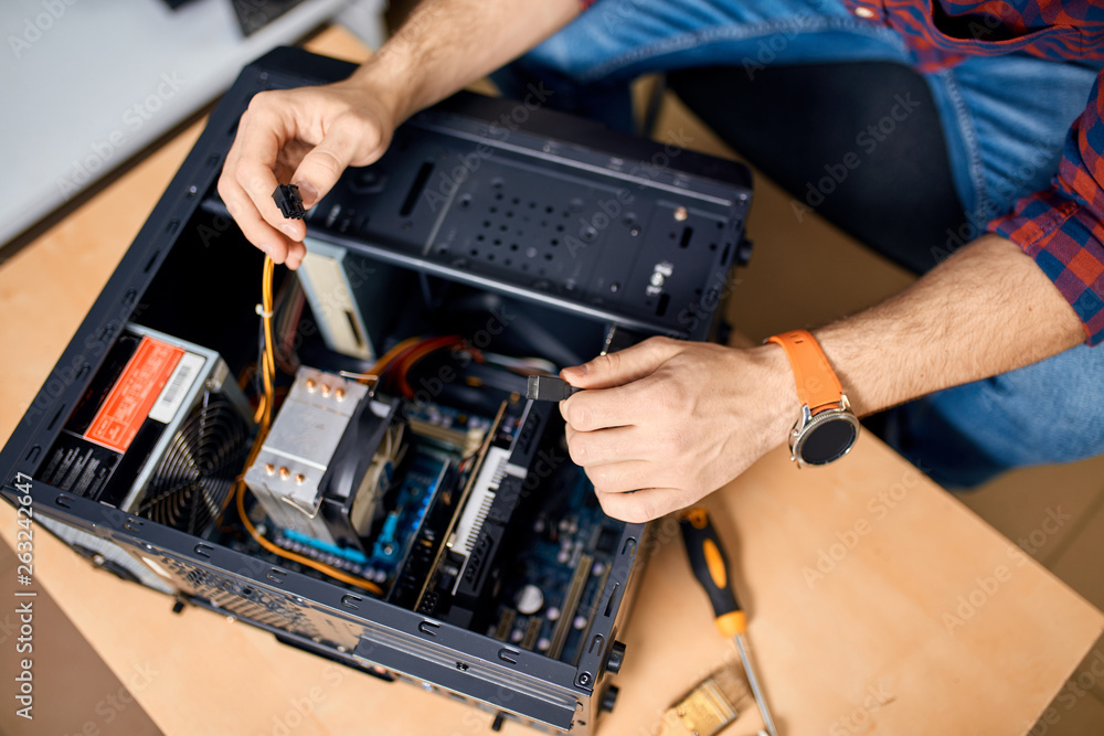professional IT specialist repairing a PC, top view cropped photo. professional IT specialist repairing a PC, top view cropped photo.