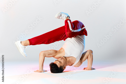 Break dancer perfected all of these basic freezes calling himself a bboy, ready to battle with anyone. It's time to get your grove on, so let's get that body moving to the beat. photo