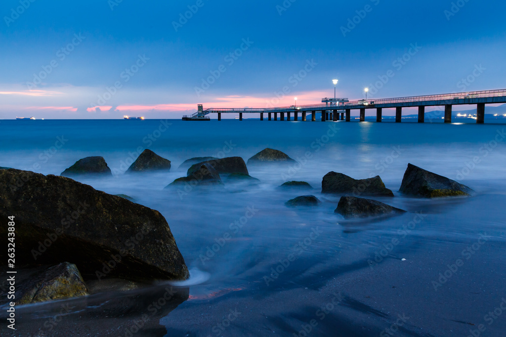 Obraz premium sunrise over bridge in the sea. Burgas bay