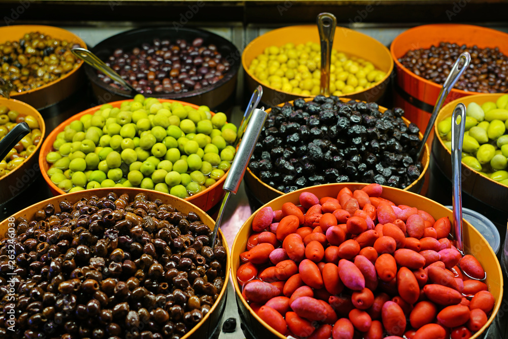 Colorful bowls of marinated olives at a food market Colorful bowls of marinated olives at a food market