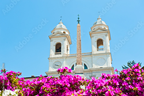 Flowers on the Spanish Steps and the church of the Santissima Trinita dei Monti in sunny spring day. Rome. Italy