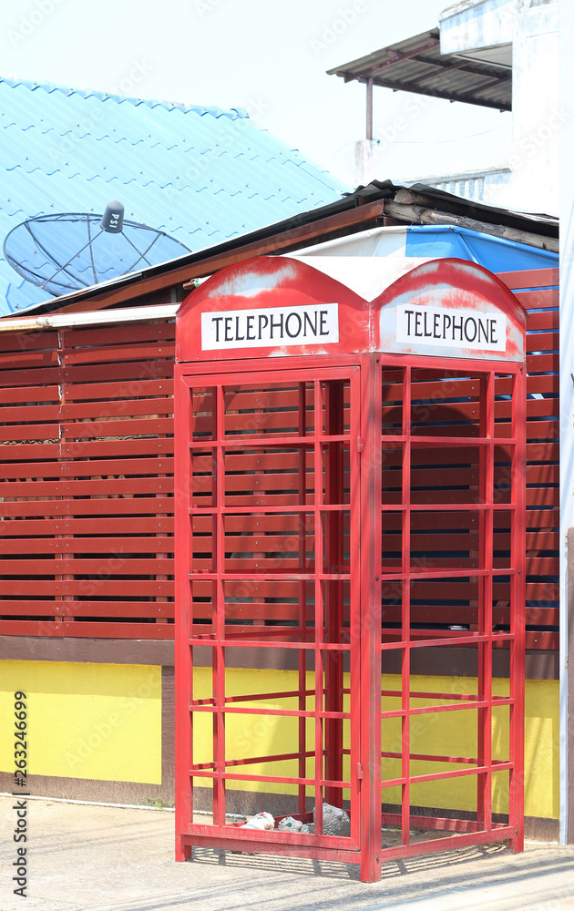 Traditional red telephone box in public phone Traditional red telephone box in public phone