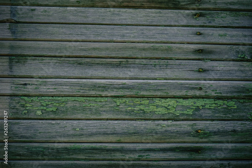 Green wooden texture as background old collapsing fence