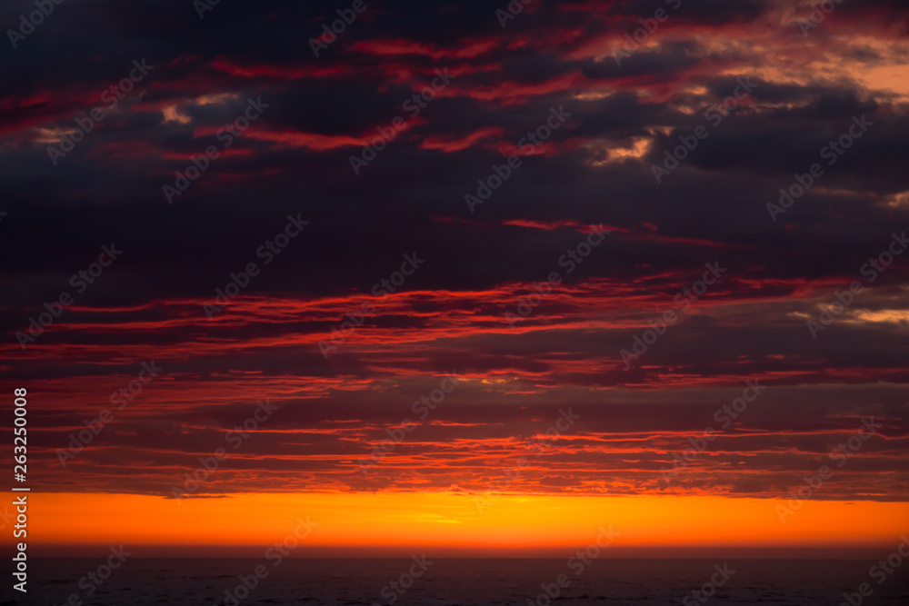 Dramatic dark clouds with red light at sunset Dramatic dark clouds with red light at sunset