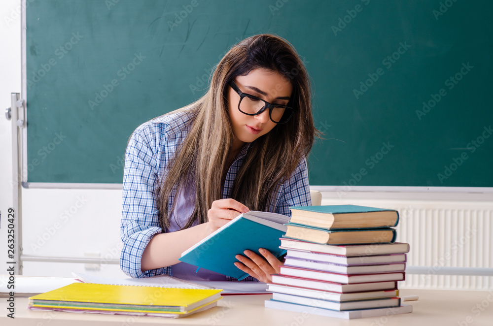 Female student in front of chalkboard Female student in front of chalkboard