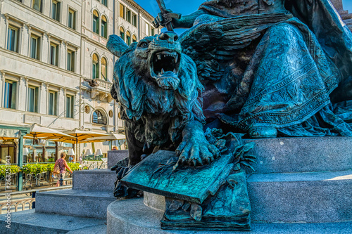 Detaled part with bronze lion of a Vittorio Emanuele II monument at embankment in Venice, Italy