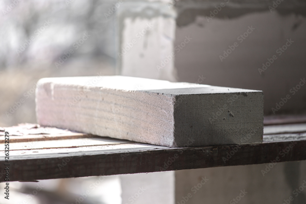 interior of a country house under construction. Site on which the walls are built of gas concrete blocks and wheelbarrow interior of a country house under construction. Site on which the walls are built of gas concrete blocks and wheelbarrow