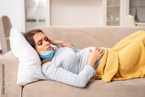 Sick pregnant woman suffering at home 