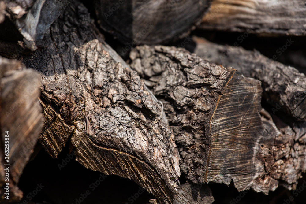 Background from stacked old brown stab wooden logs Background from stacked old brown stab wooden logs