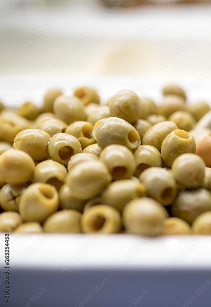 Close up of fresh and organic pitted olives on a luxury Greek buffet with a serving spoon