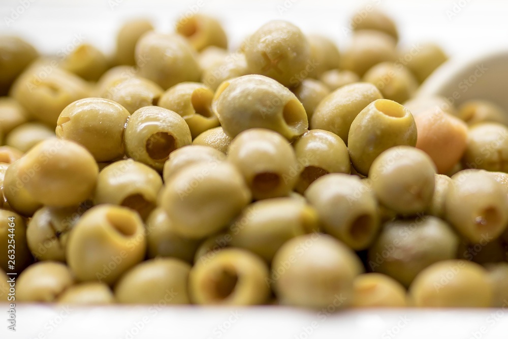 Close up of fresh and organic pitted olives on a luxury Greek buffet with a serving spoon Close up of fresh and organic pitted olives on a luxury Greek buffet with a serving spoon