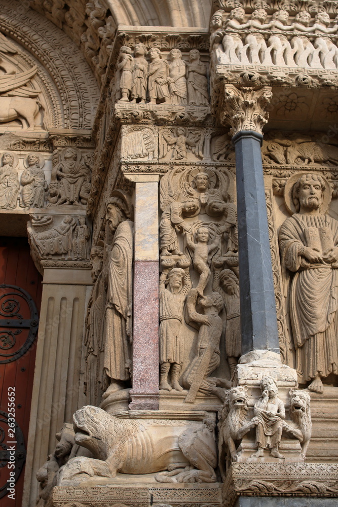 Arles, France. Romanesque figures of saints leaning on fantastic creatures on the west portal of The Church of St. Trophime. Saint Stephen, Saint Andrew