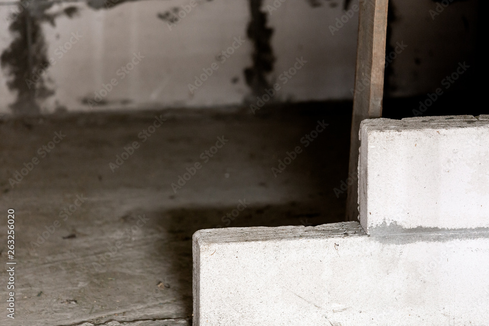 interior of a country house under construction. Site on which the walls are built of gas concrete blocks and wheelbarrow interior of a country house under construction. Site on which the walls are built of gas concrete blocks and wheelbarrow