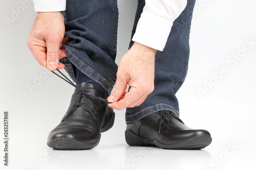Man tying shoelaces on classic shoes
