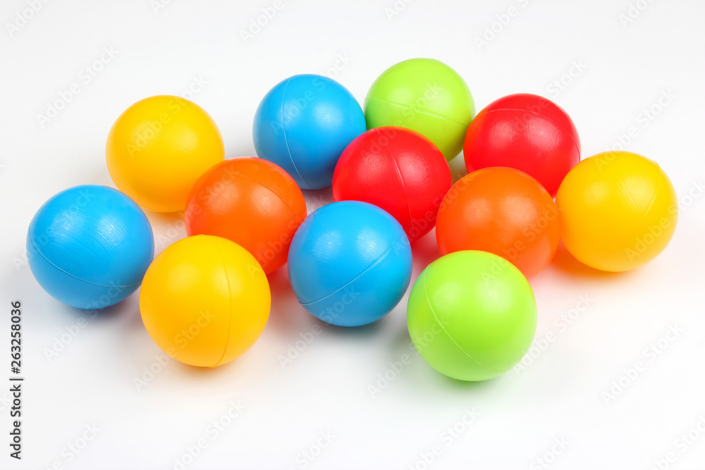 Colored plastic balls on white background