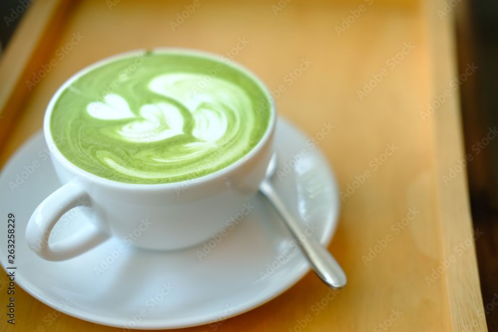 hot matcha green tea latte on wood table. hot matcha green tea latte on wood table.