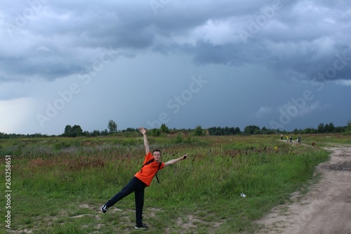 boy in orange clothes in the field