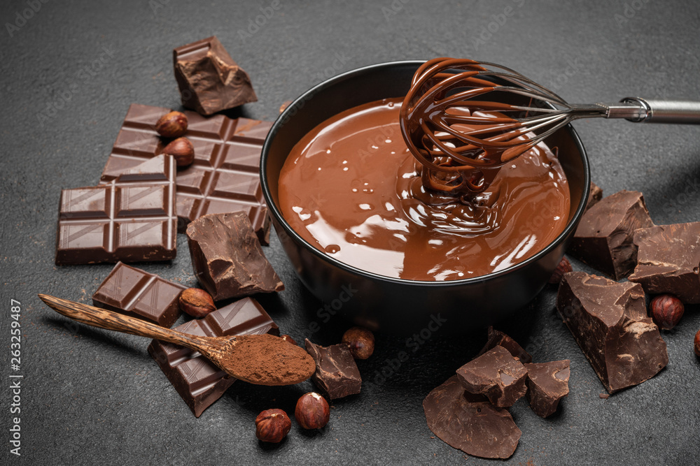 ceramic bowl of chocolate cream or melted chocolate and pieces of chocolate  on dark concrete background Stock Photo | Adobe Stock