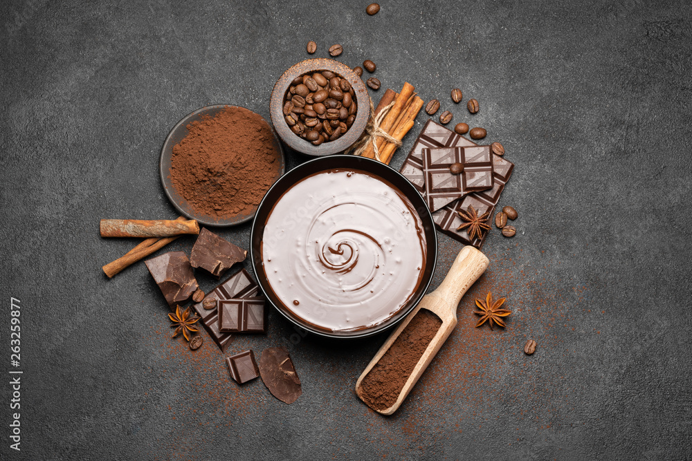 ceramic bowl of chocolate cream or melted chocolate and pieces of chocolate isolated on dark concrete background ceramic bowl of chocolate cream or melted chocolate and pieces of chocolate isolated on dark concrete background