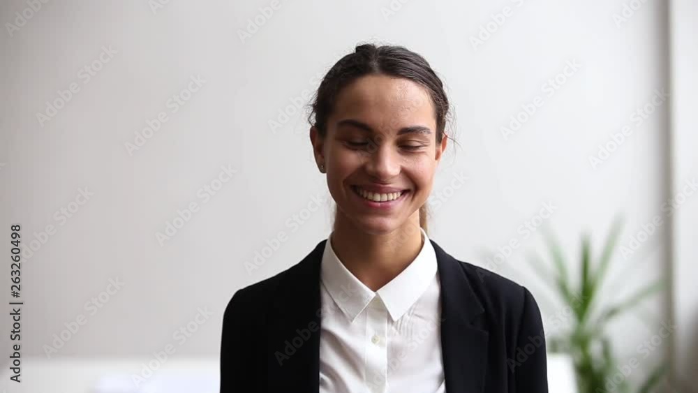 Successful confident millennial woman in suit smiling looking at camera Successful confident millennial woman in suit smiling looking at camera