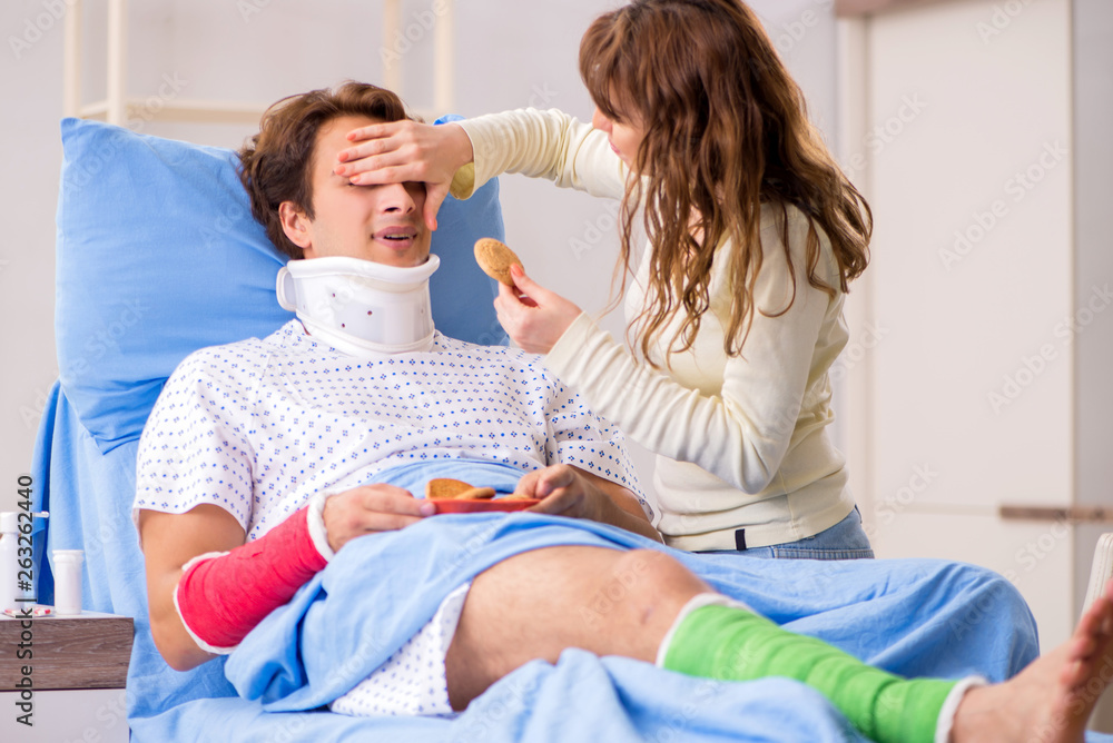 Loving wife looking after injured husband in hospital Loving wife looking after injured husband in hospital