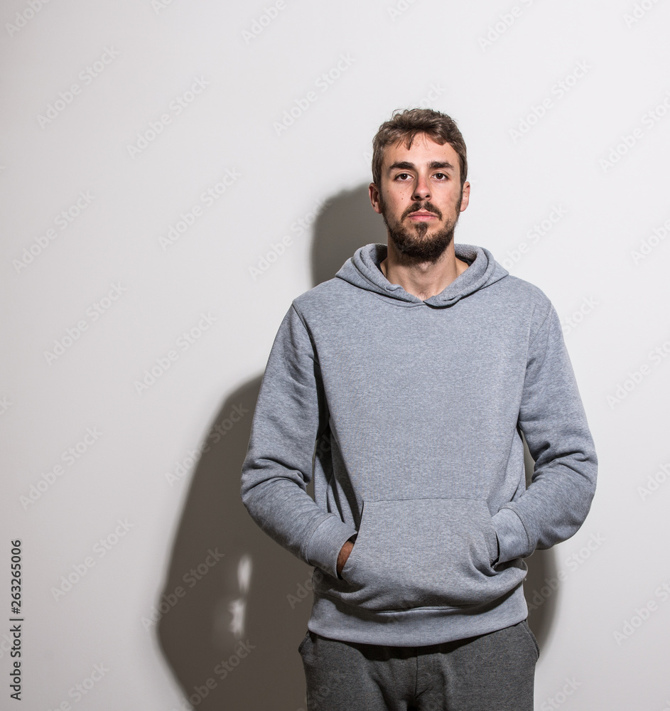 Handsome young man standing in front of white background Handsome young man standing in front of white background